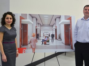 Sara Palmer and Jon Palmer of H.D. Palmer and Associates show off the conceptual drawings of their Silver St. location at an open house Wednesday. The building, formerly Elgin county's temporary courthouse, is being converted into professional office space in the coming months.