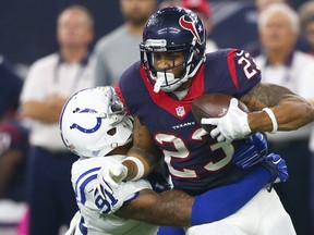 Arian Foster of the Houston Texans is tackled by Jonathan Newsome of the Indianapolis Colts October 8, 2015 at NRG Stadium in Houston.   (Ronald Martinez/Getty Images/AFP)