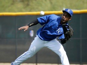 Kansas City Royals outfielder Jarrod Dyson fields a ball during spring training practice Tuesday, Feb. 23, 2016, in Surprise, Ariz. (AP Photo/Charlie Riedel)
