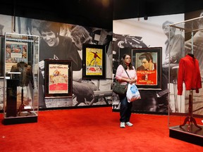 In this April 23, 2015 file photo, a woman tours an Elvis exhibition on the first day of "Graceland Presents Elvis: The Exhibition - The Show - The Experience" at the Westgate Las Vegas hotel in Las Vegas. The Elvis Presley exhibit that opened with great fanfare last year has abruptly closed amid a leasing dispute that involves hundreds of the King's artifacts. The Westgate Las Vegas Resort and Casino said it's holding the valuables from its Elvis attraction because the operators, Exhibit A Circle LLC, have defaulted in its 10-year contract with the off-Strip property. (AP Photo/John Locher, File)