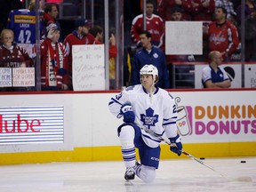 Fans hold signs as Toronto Maple Leafs centre Brooks Laich warms up before an NHL game against the Washington Capitals at the Verizon Center in Washington on March 2, 2016. (AP Photo/Alex Brandon)