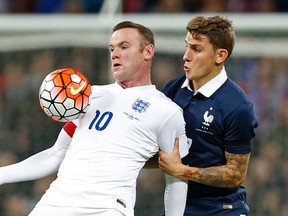 England’s Wayne Rooney (left) and France’s Lucas Digne battle for the ball during an international friendly at Wembley Stadium. (Action Images via Reuters/Carl Recine)