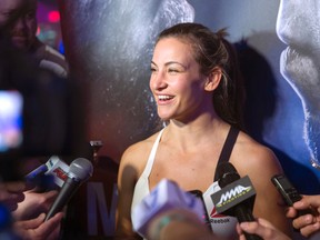 In this photo taken, Wednesday, March 2, 2016, Miesha Tate talks with reporters during open workouts for UFC 196 at MGM Grand in Las Vegas. (Steve Marcus/Las Vegas Sun via AP)