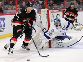 Mark Stone tries to control the puck with goalie Ben Bishop keeping close watch in the third period as the Ottawa Senators take on the Tampa Bay Lightning in NHL action at the Canadian Tire Centre in Ottawa on March 3, 2016. (Wayne Cuddington/Postmedia)