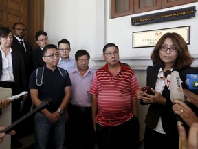 Lawyer Sangeet Deo, right, speaks to members of the media, accompanied by relatives of passengers Tan Ah Meng, his wife Chuang Hsiu Ling, and son Tan Wei Chew, who were aboard the missing Malaysia Airlines flight MH370, during a hearing for the compensation suit brought against the Malaysian government and Malaysia Airlines over claims of negligence and breach of trust, in Kuala Lumpur, Malaysia, March 4, 2016.  REUTERS/Olivia Harris