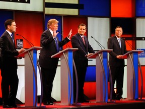 Republican presidential candidate, businessman Donald Trump, second from left, gestures as Sen. Marco Rubio, R-Fla., Sen. Ted Cruz, R-Texas, and Ohio Gov. John Kasich watch him a Republican presidential primary debate at Fox Theatre, Thursday, March 3, 2016, in Detroit. (AP Photo/Paul Sancya)