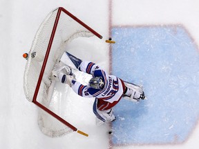 New York Rangers goalie Henrik Lundqvist (30) pushes over the goal cage to force a stoppage of play after being shaken up in a collision with teammate Ryan McDonagh during the second period an NHL hockey game against the Pittsburgh Penguins in Pittsburgh, Thursday, March 3, 2016. The Penguins won 4-1. (AP Photo/Gene J. Puskar)