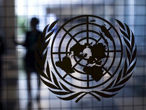 A United Nations logo is seen on a glass door in the Assembly Building at the United Nations headquarters in New York City Sept. 18, 2015.  REUTERS/Mike Segar