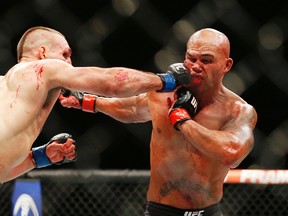 Rory MacDonald hits Robbie Lawler in their welterweight title mixed martial arts bout at UFC 189 on Saturday, July 11, 2015, in Las Vegas. (AP Photo/John Locher)