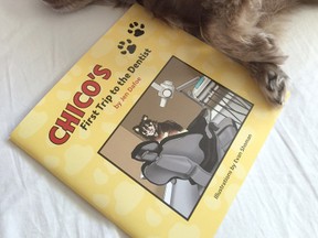 Chico, a ten-pound Peka-Tzu Chorkie, relaxes in bed with a copy of Sarnia author Jen Dafoe's book, Chico's First Trip to the Dentist. (Submitted photo)
