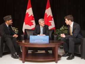 Then-prime minister Stephen Harper and Dr. Andrew Bennett, Ambassador to the Office of Religious Freedom, right, sit down with Lal Khan Malik, National President of Ahmadiyya Muslim Jama'at Canada, prior to announcing the establishment of the Office of Religious Freedom in Vaughan, Ont. on Feb. 19, 2013. (PMO/Handout/Postmedia Network)