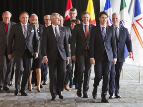 Prime Minister Justin Trudeau, second from right, walks out of the First Minister's Meeting with provincial premiers to address the media in Vancouver, March 3, 2016. (REUTERS/Ben Nelms)