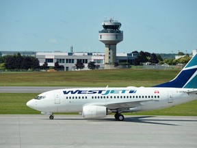 A WestJet aircraft is pictured on the tarmac in Ottawa in this July 2, 2015 file photo. (THE CANADIAN PRESS/Sean Kilpatrick)