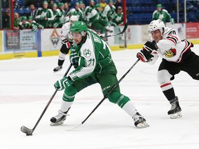 Tyler MacArthur, right, of the Owen Sound Attack, attempts to slow down David Levin, of the Sudbury Wolves, during a breakaway at the Sudbury Community Arena in Sudbury, Ont. on Friday March 4, 2016. John Lappa/Sudbury Star/Postmedia Network