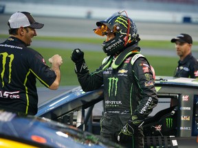 Kurt Busch, center, celebrates with teammates after winning the pole position during qualifying for the NASCAR Sprint Cup Series auto race Friday, March 4, 2016, in Las Vegas. (AP Photo/John Locher)