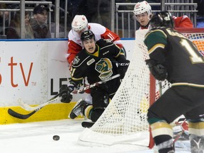 London Knights forward CJ Yakimowicz makes a pass from his knees to teammate Owen MacDonald as he is knocked to the ice by Sault Ste. Marie Greyhounds defenceman Mac Hollowell during the second period of their OHL game at Budweiser Gardens on Friday night. (CRAIG GLOVER, The London Free Press)