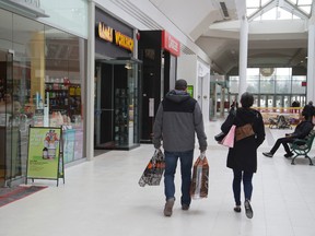 Matt Breckenridge and Tanya Schoonderwaldt of Woodstock carry their purchases through White Oaks Mall in London. Local jeweller Colin Nash, who is building a new store, says there?s growing confidence among consumers. (MIKE HENSEN, The London Free Press)