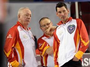 Nunavut skip Wade Kingdon and third Dennis Mason speak with coach Greg Corrigan (left) shortly before forefiting the game against the Northwest Territories during a pre-qualifying match against the Yukon at the Tim Hortons Brier, Thursday March 3, 2016, in Ottawa.