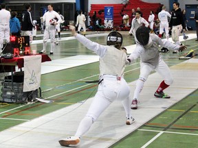 Siobhan Drysdale of the University of Toronto defeats Belanna McLean of the Royal Military College of Canada 15-14 in foil at the Ontario Fencing Association’s 2016 Provincial Championships hosted by RMC at the Kingston Military Community Sports Centre in Kingston, Ont. on Saturday March 5, 2016. Steph Crosier/Kingston Whig-Standard/Postmedia Network