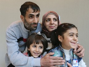 Syrian newcomers Rashad Al-Tinawi (L)and his wife Manal along with their son Hamudi 4, and daughter Bayan 7, enjoy a lunch and children's activities sponsored by World Vision Canada and the Mennonite Central Committee on Saturday March 5, 2016. Veronica Henri/Toronto Sun/Postmedia Network