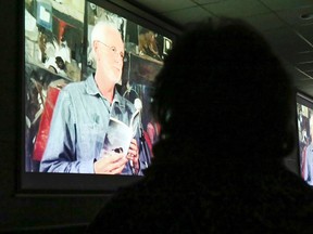 An audience at the CORE Centre watches Living Poetry with Rick Patrick, a short film on the life and writing of the Madoc-area poet. It was made by his neighbour, David Maltby.