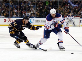 Buffalo Sabres left wing Nicolas Deslauriers (44) and Edmonton Oilers defenseman Adam Pardy (6) go after the puck during the third period at First Niagara Center. Edmonton beats Buffalo 2 to 1 in overtime.