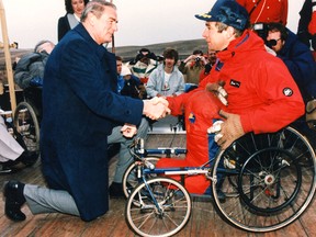Then-premier Don Getty welcomes Rick Hansen to Alberta during Hansen's Man in Motion World Tour in the 1980s. (FILE PHOTO)