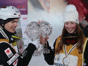 Mikael Kingsbury, left, and Chloe Dufour-Lapointe, both of Canada, display their Crystal Globe trophies after the World Cup freestyle skiing final city event in Moscow, Russia, on Saturday, March 5, 2016.  (AP Photo/Ivan Sekretarev)