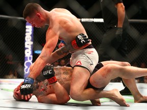 Nate Diaz pins Conor McGregor against the mat during UFC 196 at MGM Grand Garden Arena. Mandatory Credit: Mark J. Rebilas-USA TODAY Sports