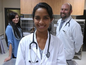 Dr. Tsiky Rajaonarivelo (centre) from Madagascar is seen with Dr. Jonas Watson (right) and veterinarian nurse Brittany Semeniuk at Tuxedo Animal Hospital in Winnipeg on Friday, March 4, 2016. The three met in Madagascar last year as part of the Mad Dog Initiative, which protects endangered wildlife in a national forest. Rajaonarivelo is in Winnipeg for five weeks to complete her surgical training. (Kevin King/Winnipeg Sun/Postmedia Network)