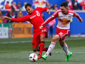 Toronto FC defender Steven Beitashour and New York Red Bulls midfielder Sacha Kljestan battle for the ball during first-half action at Red Bull Arena in Harrison, N.J., on March 6, 2016. (Noah K. Murray/USA TODAY Sports)