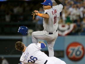 In this Oct. 10, 2015, file photo, New York Mets shortstop Ruben Tejada, goes over the top of Los Angeles Dodgers' Chase Utley who broke up a double play during the seventh inning in Game 2 of the National League Division Series in Los Angeles. (AP Photo/Gregory Bull, File)