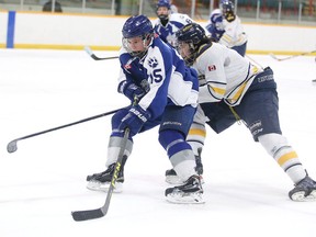 Sudbury Nickel Capital Wolves Damien Giroux and Kapuskasing Flyers Gabriel John-George battle for the puck during Great North Midget League playoff action in Sudbury, Ont. on Sunday March 6, 2016. Gino Donato/Sudbury Star/Postmedia Network