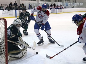 Kingston Voyageurs Zach Emelifeonwu, left, and Brandon Nadeau look for the puck in front of Cobourg Cougars goalie Stefano Durante during Game 2 of an Ontario Junior Hockey League North-East Conference quarter-final playoff series at the Invista Centre on Sunday. The Voyageurs won 5-2. (Ian MacAlpine/The Whig-Standard)