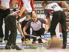 Chris Schille of Team Northwest Territories guides the sweepers as the Tim Horton's Brier continues on Sunday at TD Place in Ottawa. (Wayne Cuddington)