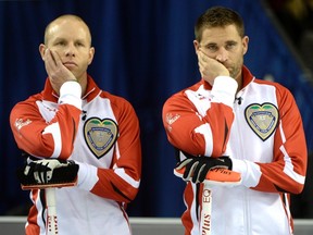 Team Canada skip Pat Simmons, left, and third John Morris ponder during a draw against Quebec at the Tim Hortons Brier in Ottawa on Saturday. (Justin Tang/The Canadian Press)