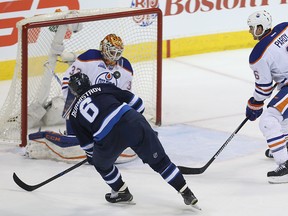 Winnipeg Jets centre Alex Burmistrov is stopped by Edmonton Oilers goaltender Cam Talbot as Adam Pardy defends in Winnipeg on Sun., March , 2016. Kevin King/Winnipeg Sun/Postmedia Network