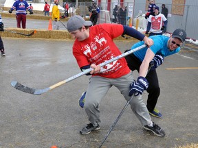 Trevor Skinner (left) of the Back Door Favourites tries to shake free from the checking of Tyler Cook of the Perth County Thrashers during action from the 1st annual Road Hockey tournament at Perth County Chrysler on Saturday, March 5 in Mitchell. Proceeds from the event, an estimated $8,000, went to benefit the Seigner family of Mitchell, who were in a single vehicle accident Jan. 28 that left Michelle Seigner hospitalized with major injuries. Spearheaded by Perth County Chrysler and McNain TV & Communication, plenty of businesses and organizations lent their support to the cause. ANDY BADER/MITCHELL ADVOCATE