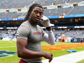 Washington Redskins quarterback Robert Griffin III (10) warms up before the game against the Chicago Bears at Soldier Field. Mike DiNovo-USA TODAY Sports