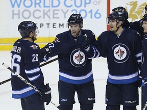 Winnipeg Jets centre Mark Scheifele (centre) celebrates his second-period goal against the Edmonton Oilers with Blake Wheeler, Drew Stafford, Jacob Trouba and Tyler Myers (from left) in Winnipeg on Sun., March , 2016. Kevin King/Winnipeg Sun/Postmedia Network