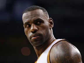 Cleveland Cavaliers' LeBron James looks on in the first half of an NBA basketball game against the Phoenix Suns in Cleveland.  (AP Photo/Tony Dejak, File)