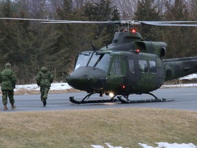 BRUCE BELL/The Intelligencer
Members of the Disaster Assistance Response Team (DART) prepare to unload a Grffon helicopter at Sandbanks Provincial Park on Monday as part of the 11-day mock disaster training exercise.