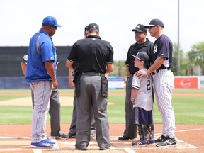 New York Yankee special guest Landis Sims from Indiana joins manager Joe Girardi #28 for the lineup exchange at home plate prior to the start of the game against the Toronto Blue Jays at George M. Steinbrenner Field on March 23, 2014 in Tampa, Florida.  (Leon Halip/Getty Images/AFP)