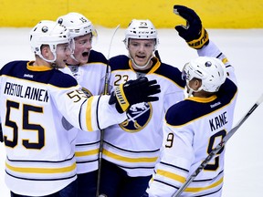 Buffalo Sabres center Jack Eichel (15) celebrates with defenceman Rasmus Ristolainen (55) and left wing Evander Kane (9) and center Sam Reinhart (23) after scoring a power play goal in the second period against the Arizona Coyotes at Gila River Arena. Matt Kartozian-USA TODAY Sports