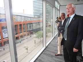 Jim August (left) looks on as Eric Wiens of Stantec conducts a tour of  the Centrepoint development in Winnipeg, Man. Monday June 30, 2015.