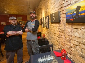 Chef Tom Donaldson and owner Mike Small stand near an art wall inside the Victoria Tavern, which is set to open the doors to the public again in London at 4 p.m. on Friday. (CRAIG GLOVER, The London Free Press)