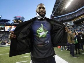Injured Seattle Seahawks wide receiver Ricardo Lockette wears a neck brace as he arrives at CenturyLink Field before the Seahawks' NFL football game against the Arizona Cardinals, while wearing a T-shirt with a team hand signal of the letter "L" which means "Love our Brothers," Sunday, Nov. 15, 2015, in Seattle. (AP Photo/Elaine Thompson)