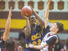 Oakwood’s Josis Thomas drives the basket on Adam Metzen of St. Mary’s in yesterday’s OFSAA opener. The Barons held St. Mary’s to five second-half points en route to a 70-24 win. (DAX MELMER, Postmedia Network)