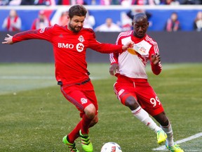 Toronto FC defender Drew Moor and New York Red Bulls forward Bradley Wright-Phillips battle for the ball during second half at Red Bull Arena.The Toronto FC defeated the New York Red Bulls 2-0. (Noah K. Murray/USA TODAY Sports)