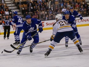 Maple Leafs forward Zach Hyman skirts around Sabres defenceman Carlo Colaiacovo during NHL action in Toronto on Monday, March 7, 2016. (Dave Thomas/Toronto Sun)